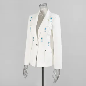 Side view detail of white blazer featuring elegant blue rhinestone water-drop accents