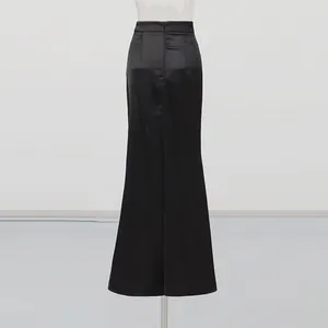 Detail view showing the back of a high-waisted black satin maxi skirt with zipper
