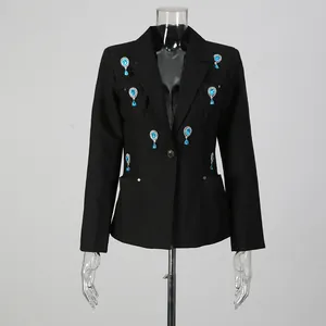 Detail shot of black blazer with elegant blue teardrop rhinestone embellishments