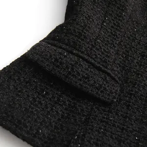 Macro detail of high-quality black tweed fabric with shimmering silver metallic threads
