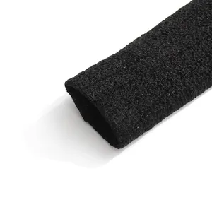 Detail view of black tweed fabric texture on a Chanel-style women jacket sleeve.