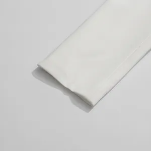 Detailed close-up of a white blazer sleeve cuff showing premium fabric texture and seams