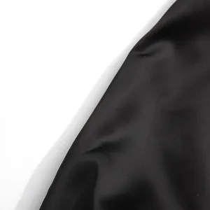 Close-up detail of smooth black fabric with a subtle silky sheen finish for women's set