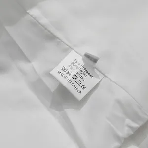 Detailed close-up of white women's suit jacket care label showing fabric composition