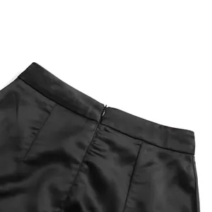 Close-up of invisible zipper and smooth satin fabric on black high waist bodycon skirt
