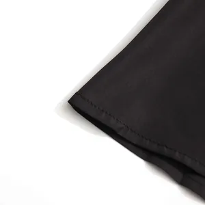 Close-up of the delicate stitching on the hem of a black elegant suit skirt