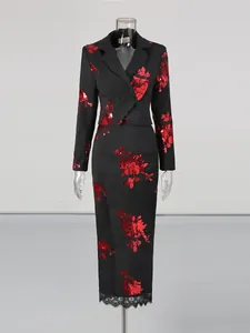 Elegant black two-piece suit featuring red sequin floral blazer and lace hem midi skirt.
