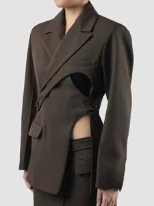 Detailed side view of dark brown asymmetrical blazer with unique waist cut-out design