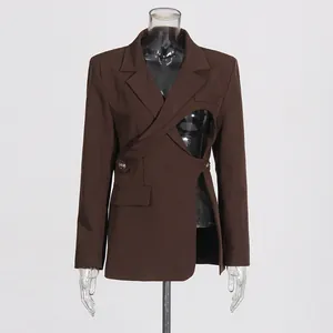 Detail of modern brown blazer featuring unique asymmetric hollow-out cutout design