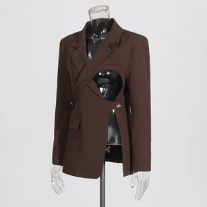 Detailed view of women's brown asymmetrical cutout blazer with hollow waist design