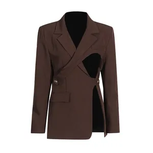 Detail view of dark brown asymmetrical blazer featuring a unique cutout design.
