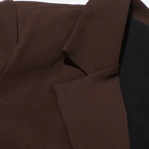 Close-up of notch lapel and fine fabric texture on a brown British style blazer