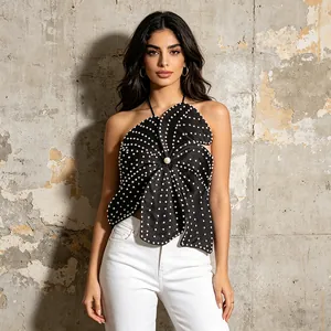 Macro view of black flower-shaped halter top decorated with elegant white pearl beads