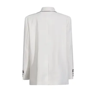 Back view of white elegant women's blazer with black piping and cuff button details