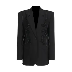 Detailed view of black blazer with sequined butterfly embellishments and slim button design