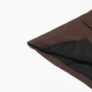 Close-up of brown blazer hem with black lining detail and high-quality stitching