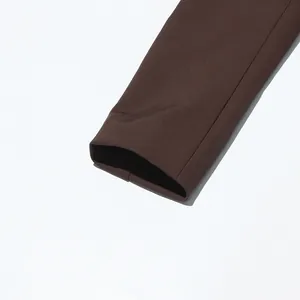 Detailed close-up of the smooth cuff on a brown British style suit jacket