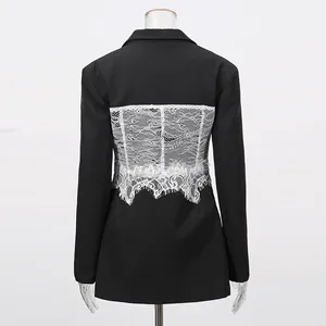 Detailed macro view of the white lace patchwork on the back of this black blazer