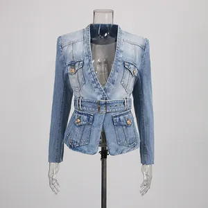 Detail shot of a vintage distressed denim blazer with gold buttons and waist belt.