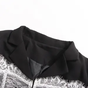 Close-up detail of black V-neck blazer featuring elegant white lace splicing on lapels