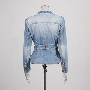 Back view of a distressed light blue denim blazer with gold buttons and cinched waist.