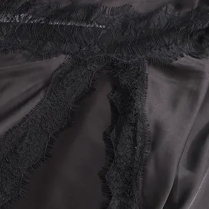 Detailed close-up view of black satin fabric with fine eyelash lace trim for skirts