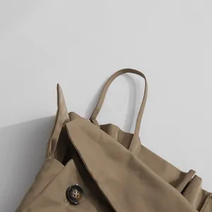 Close-up detail of khaki elegant suspender jumpsuit showing fabric and button detail