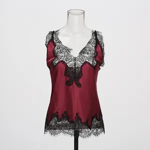 Detailed view of wine red silk camisole featuring delicate black eyelash lace trim.