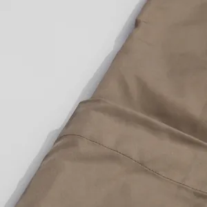 Close-up of khaki twill fabric showing fine stitching and high-quality smooth texture