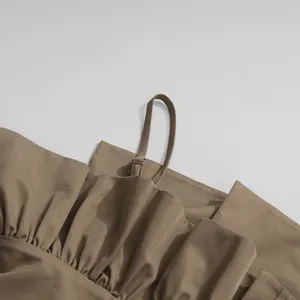 Close-up detail of khaki jumpsuit featuring adjustable spaghetti strap and ruffled bust