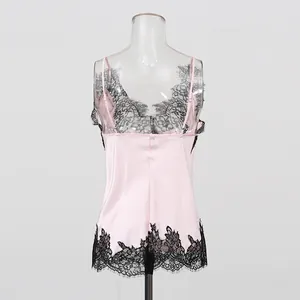 Detailed back view of a pink silk camisole with black lace trim and elegant thin straps