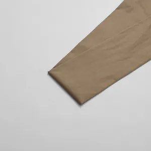 Detail shot showing the smooth khaki fabric texture of an elegant women's jumpsuit