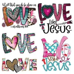 Close-up detail of Love and Like Jesus themed heat transfer patches with leopard heart patterns