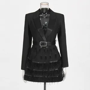 Detailed macro view of a luxury blazer dress featuring ostrich feather patchwork and belt.