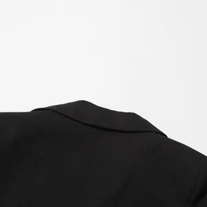 Detailed macro view showing the clean stitching and fabric texture of a black blazer collar