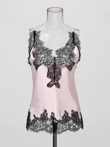 Elegant pink silk camisole with black lace trim and V-neckline on clear mannequin