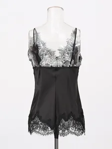 Elegant black silk-like satin camisole with delicate lace trim on transparent mannequin