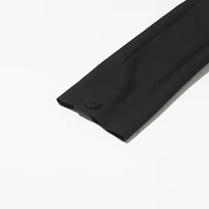 Macro detail of high-quality black blazer sleeve cuff with a matching button finish.