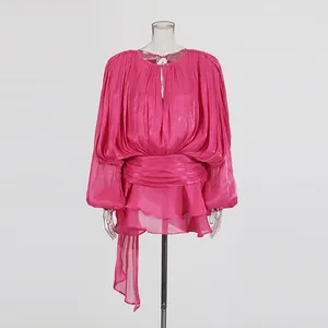 Detail of fuchsia long puff sleeve mini dress with ruffled hem