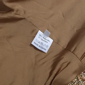 Close-up of care label showing 95% polyester and 5% spandex on brown lining