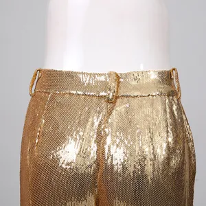 Close-up of high-waist gold sequin trousers showing sparkling material and belt loops
