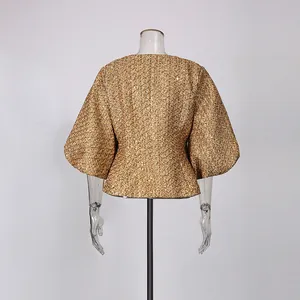 Detailed back view of a shimmering gold French style jacket with puff sleeves and cinched waist