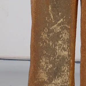 Detailed close-up showing the dense gold sequin texture of the stylish trouser fabric