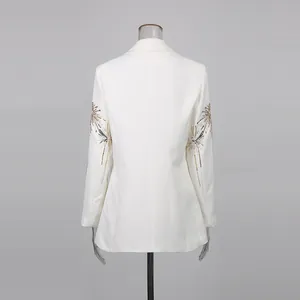 Detailed back view of white blazer with elegant gold firework embroidery detail