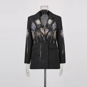 Detailed view of elegant black blazer with golden fireworks embroidery and slim fit.