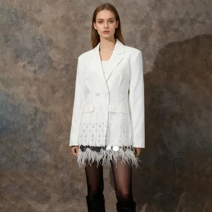 Detailed view of elegant white blazer with luxury ostrich feather and shell trim hem