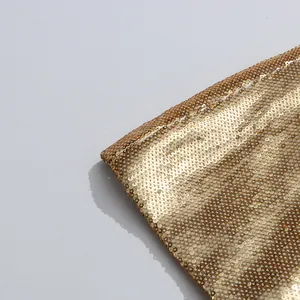 Detailed macro view of the shimmering high-density gold sequins on this elegant suit set