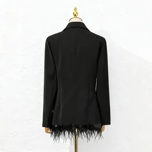 Detail view of black blazer with ostrich feather and sequin fringe hem on mannequin