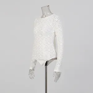Detailed side view of a white lace long-sleeve bodysuit with sheer floral patterns.