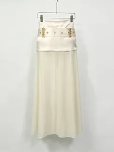 Elegant off-white sheer tulle maxi skirt with high waist and gold hardware accents
